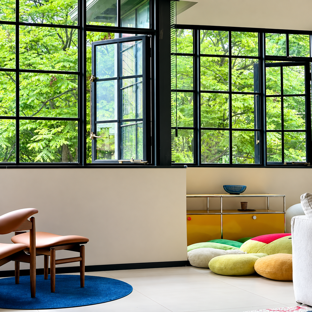 Black French casement windows overlooking a leafy garden